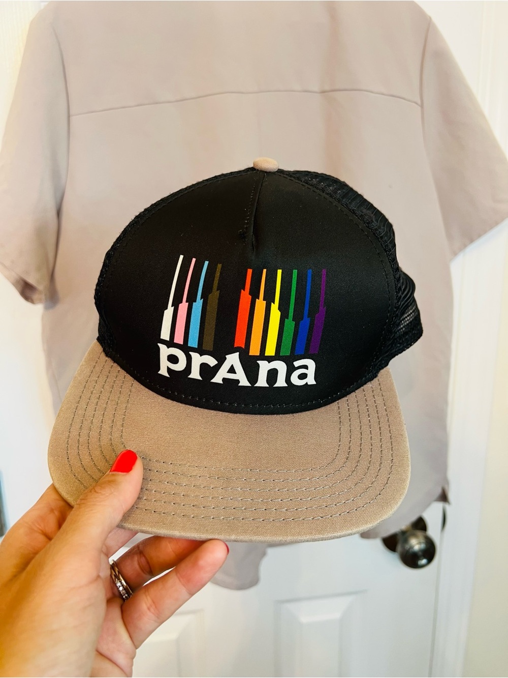Prana Black Trucker Hat with Rainbow Stripe Logo and Tan Brim